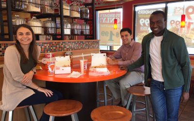 From left: Roma Romaniv, Joaquin Sanchez and Stephen Mwangi—the team of undergraduate finance students who took place in the Cornell Stock Pitch Challenge—pictured at a Popeyes Restaurant. (UConn School of Business)